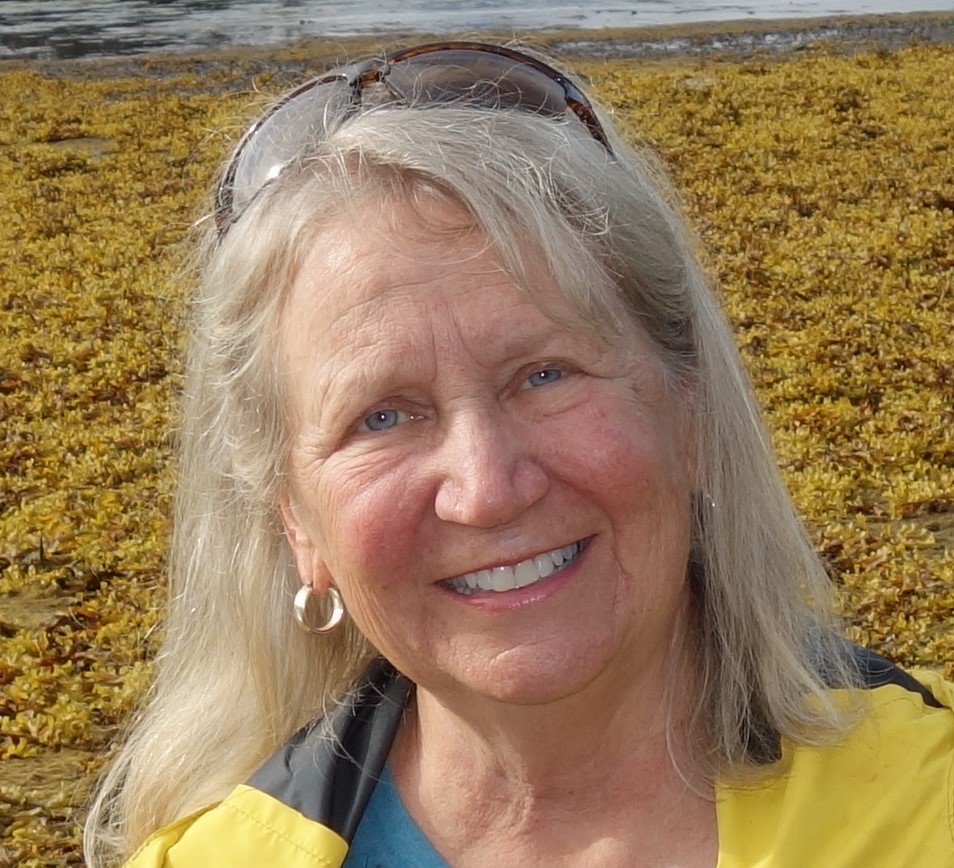 The author standing on the tidal flat in front of her Alaskan cabin. Credit: Frank Moore